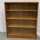 Herbert Gibbs: A mid 20th century bookcase with four glass sliding doors, 92 x 24 x 113 cm H. Not