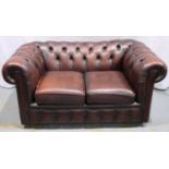 A 20th century ox blood red leather Chesterfield style two seat sofa. Not available for in-house P&P