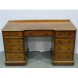 A Victorian burr walnut Heal and Son twin pedestal desk, with inverted break front and fitted with