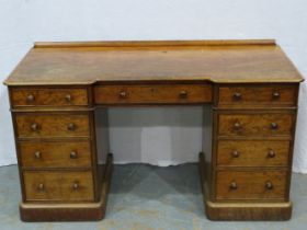 A Victorian burr walnut Heal and Son twin pedestal desk, with inverted break front and fitted with