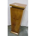 A 20th century golden oak ecclesiastical tapering pedestal, with cross affixed to the body, three