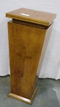 A 20th century golden oak ecclesiastical tapering pedestal, with cross affixed to the body, three