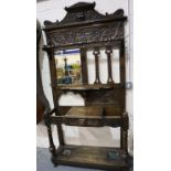 A substantial Victorian oak asymmetric hall stand, heavily carved with single drawer, bevelled