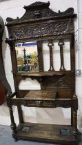 A substantial Victorian oak asymmetric hall stand, heavily carved with single drawer, bevelled