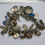 Hallmarked silver charm bracelet with forty six charms, 97g, L: 18 cm. UK P&P Group 1 (£16+VAT for