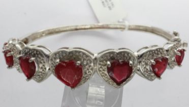 925 silver bangle set with seven heart shaped rubies, D: 70 mm. UK P&P Group 1 (£16+VAT for the