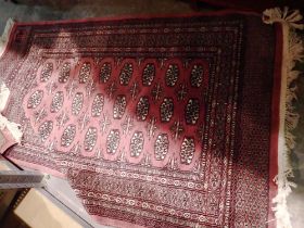 Red ground woollen floor rug. Not available for in-house P&P