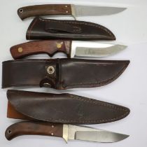 Two Rhino knives with leather sheaths and a KMV hunting knife (3). UK P&P Group 2 (£20+VAT for the