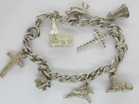 White metal charm bracelet with eight charms, L: 18 cm. UK P&P Group 1 (£16+VAT for the first lot