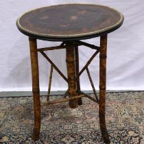 Oriental bamboo lacquered table with bird decoration on three bamboo supports, D: 53 cm. Not