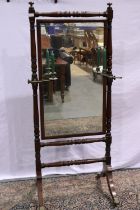 Victorian walnut cheval mirror with turned stand and brass claw castors and girandole candle