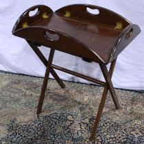 Mahogany butlers tray table with brass hinged on a folding base, 70 x 40 x 80 cm. Not available