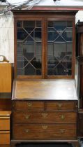 A George III cross banded walnut bureau bookcase with twin astragal glazed doors, b above a fitted