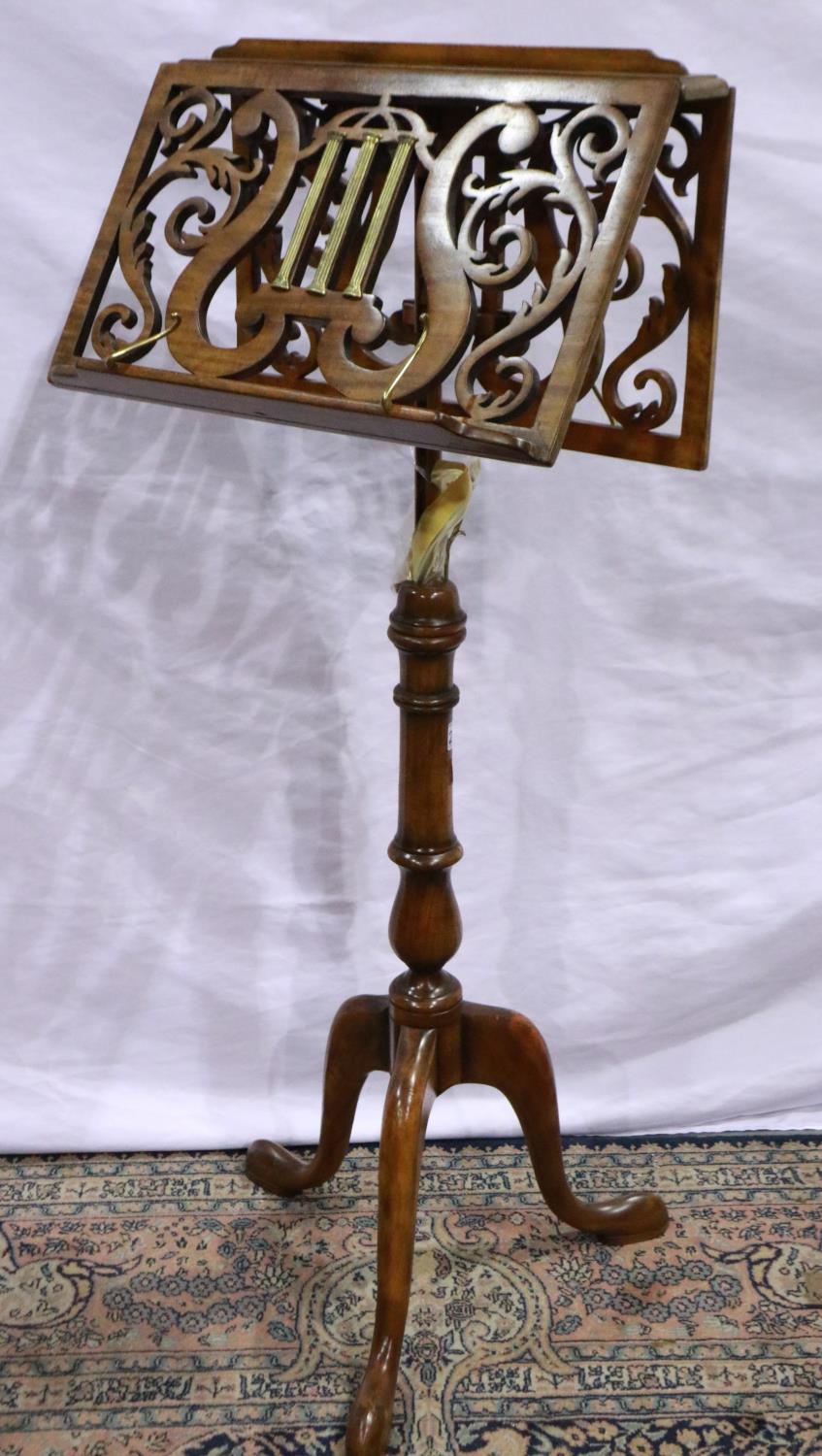 Walnut music stand on tripod supports with pad feet, wood is overall in good condition with slight