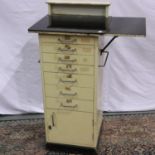 Cream seven drawer single cupboard glass topped dental cabinet 47 x 43 x 102cm. Not available for