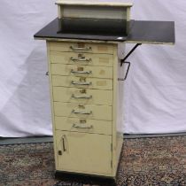 Cream seven drawer single cupboard glass topped dental cabinet 47 x 43 x 102cm. Not available for