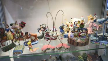 Thirteen Disney figurines including Disney Showcase Collection examples, largest H: 24 cm. Not