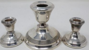 Pair of hallmarked silver candlesticks and a larger example (3), Birmingham assay, largest H: 85 mm.