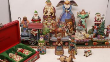 Thirteen Jim Shore Christmas figurines including a train, some items with damages, please check