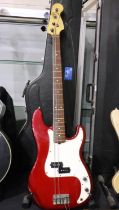 Fender Precision bass guitar in red, numbered N 59436, 1990s, with fitted hard case.