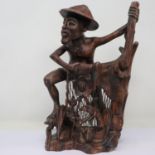 Carved hardwood Oriental fisherman, H: 32 cm. UK P&P Group 2 (£20+VAT for the first lot and £4+VAT