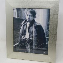 Framed photograph signed by Bob Dylan, certificate of authenticity in back of frame. Not available