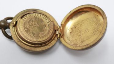 Victorian brass sovereign case with interior sprung mechanism, with a George III brass gambling