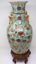 Chinese enamelled twin handled vase, decorated with birds, butterflies and flora, H: 44 cm, on a