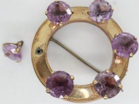 Unmarked gold brooch set with with six large amethysts, one amethyst loose but present, also lacking