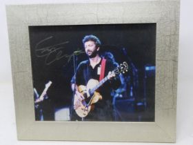 Framed photograph signed by Eric Clapton, certificate of authenticity in back of frame. Not