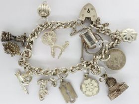 Hallmarked silver charm bracelet with twelve charms, padlock clasp and safety chain, L: 18 cm,