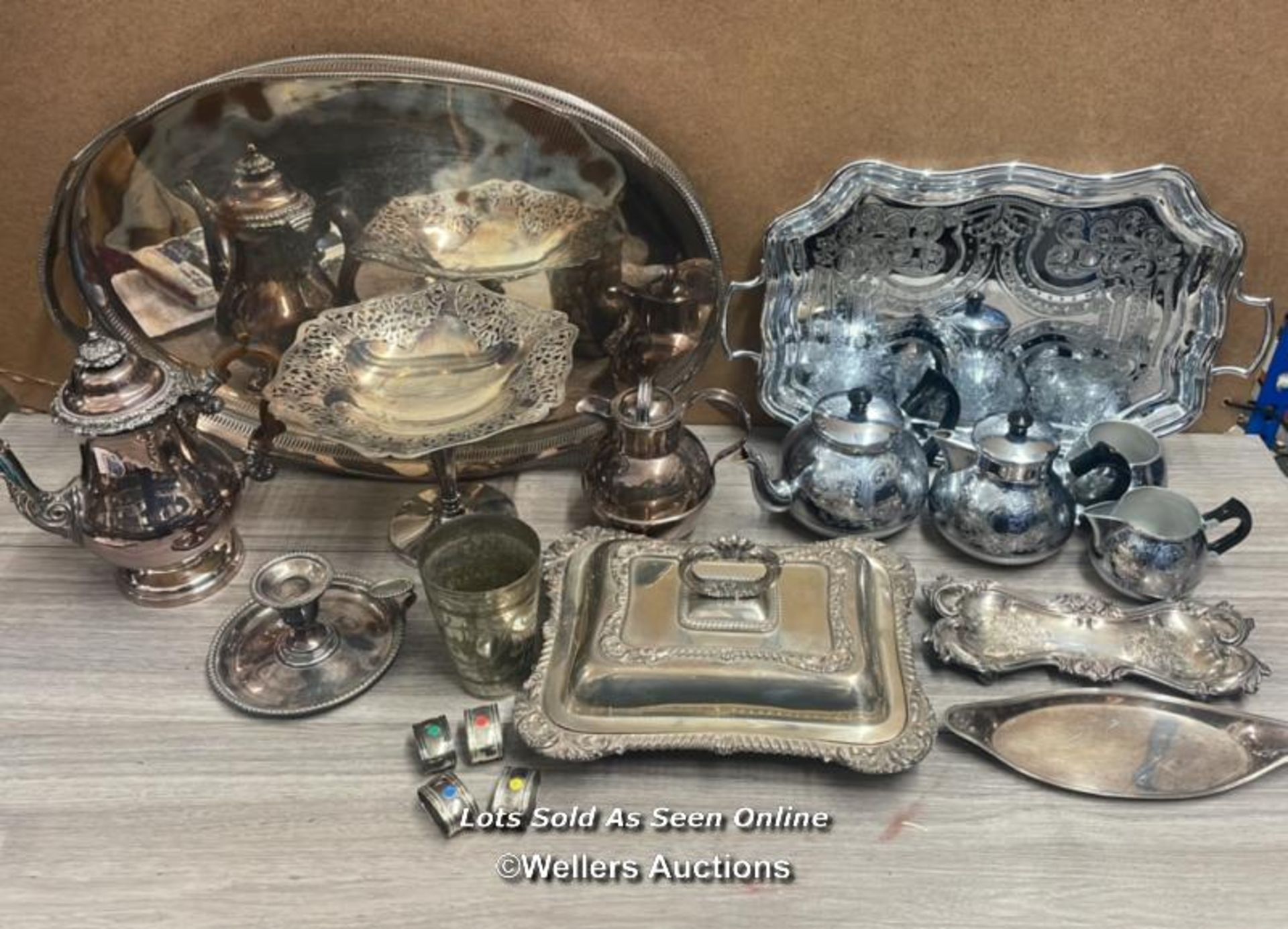 A LARGE QUANTITY OF ANTIQUE METAL WARE INCLUDING TRAYS, LARGE SERVING DISH, COFFE & TEA POTS AND