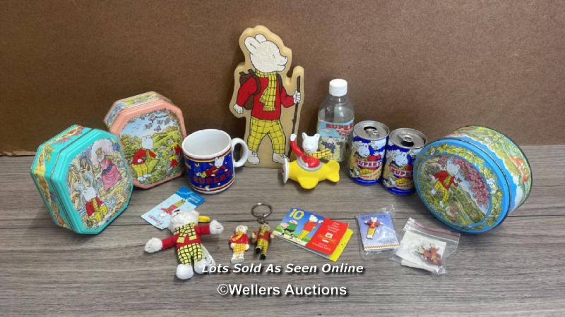 RUPERT BEAR MEMORABILIA INCLUDING MUG, TINS, SPONGE, CANS, STAMPS AND KEYRINGS