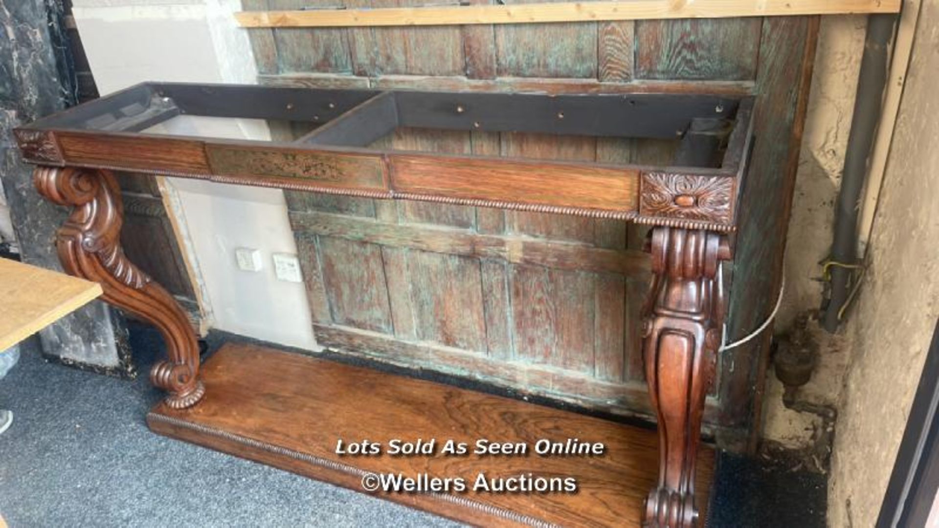 A CARVED HALLWAY TABLE WITH MARBLE TOP. THE TABLE NEEDS TO BE FIXED TO A WALL BEFORE THE MARBLE IS