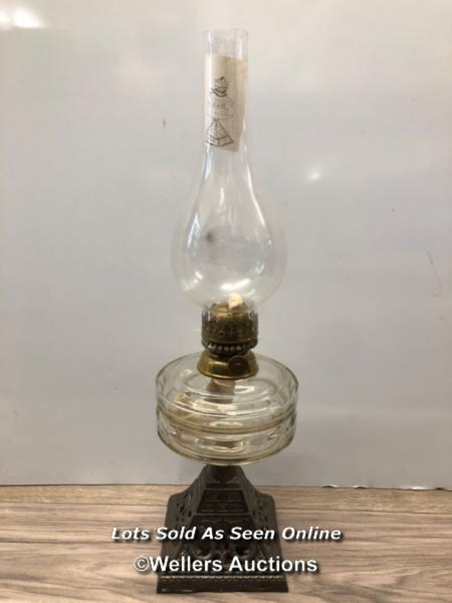 *OIL LAMP WITH GLASS RESERVOIR, CAST IRON BASE, YOUNGS BRILLIANT
