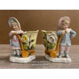 A PAIR OF VICTORIAN SPILL VASES MODELLED AS CHILDREN WITH BASKETS