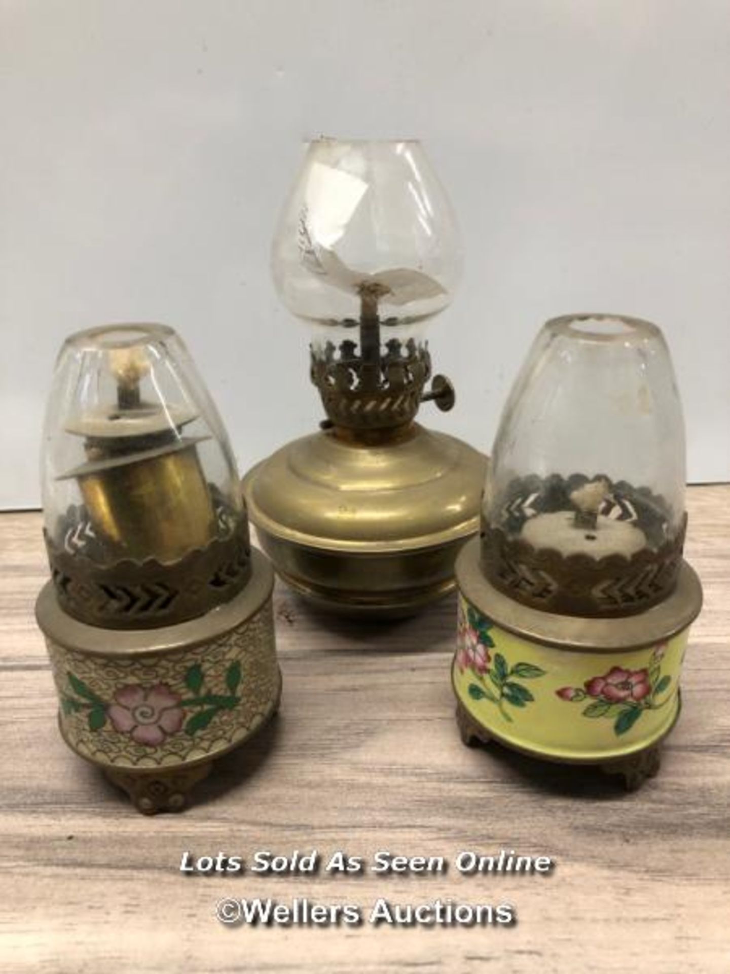 *TWO SMALL CLOISONEE PARAFFIN LAMPS AND A SIMILAR BRASS EXAMPLE