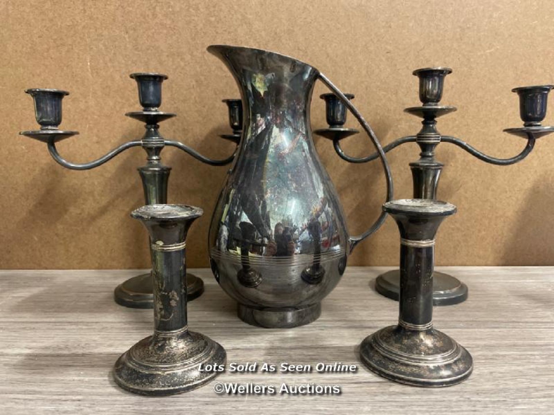METAL WARE INCLUDING WATER JUG, TWO 3 ARMED CANDLE HOLDERS AND TWO SINGLE CANDLE HOLDERS (5)