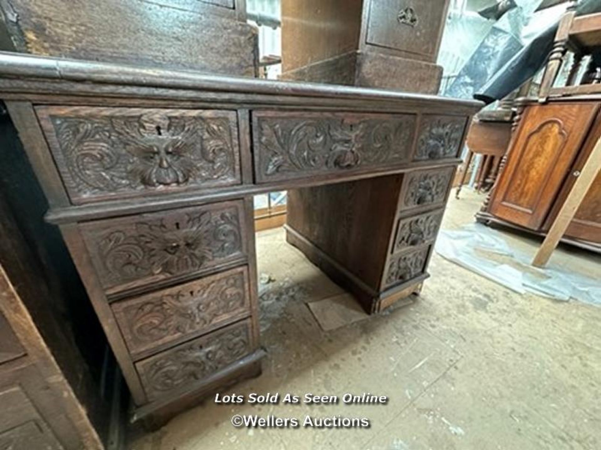 OAK CARVED DESK WITH NINE DRAWERS, 41.5 X 28.5 X 29.5 INCHES / LOCATED AT VICTORIA ANTIQUES,