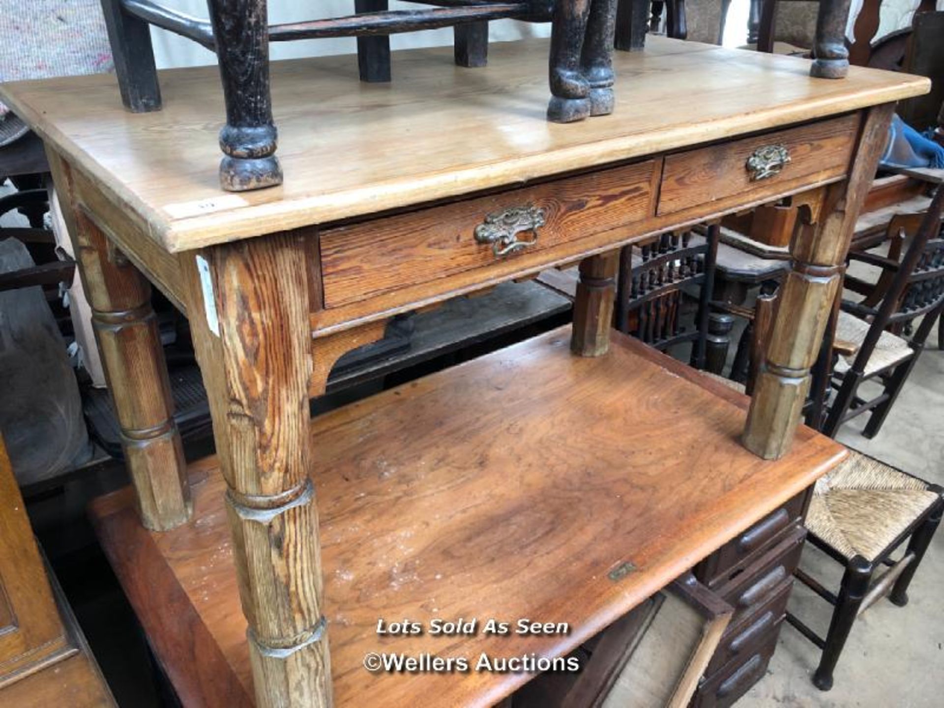PINE TABLE WITH TWO DRAWERS AND BRASS HANDLES, 51 X 27 X 31 INCHES / LOCATED AT VICTORIA ANTIQUES,