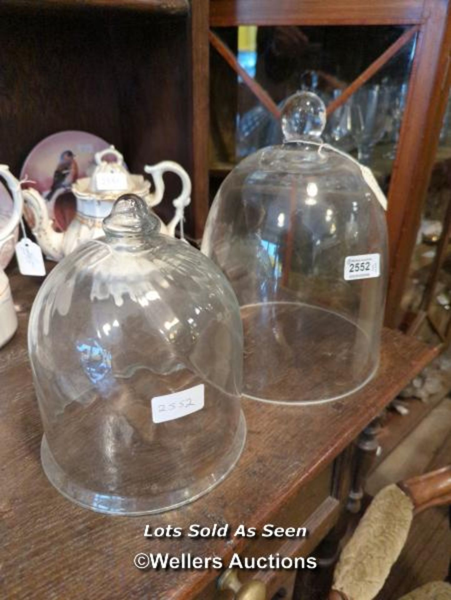 *TWO GLASS DOMES, DIAMETERS 22CM AND 18.25CM / LOCATED AT VICTORIA ANTIQUES, WADEBRIDGE, PL27 7DD