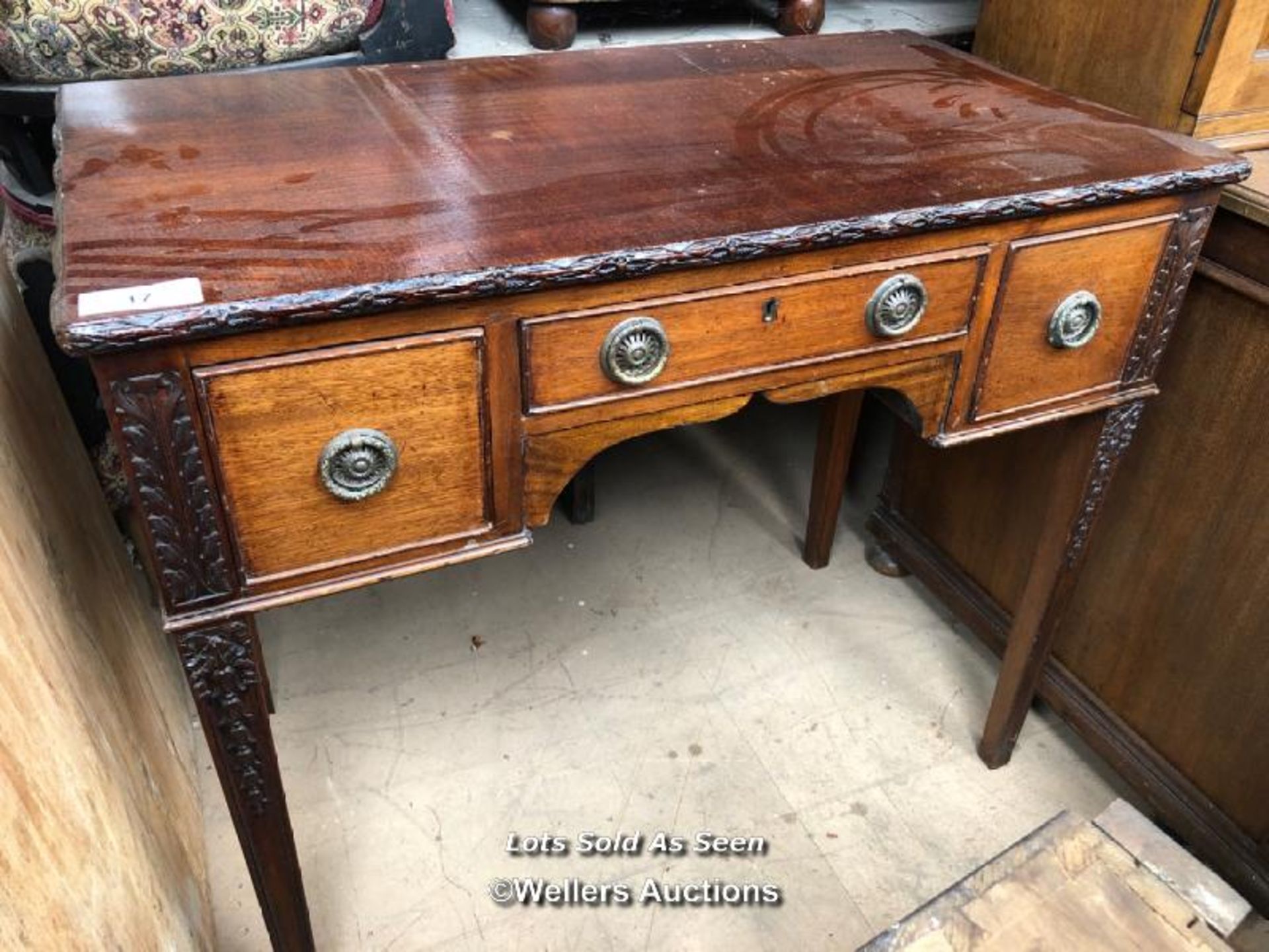 DECORATIVELY CARVED SMALL DESK WITH THREE DRAWERS, 36 X 20 X 31.5 INCHES / LOCATED AT VICTORIA
