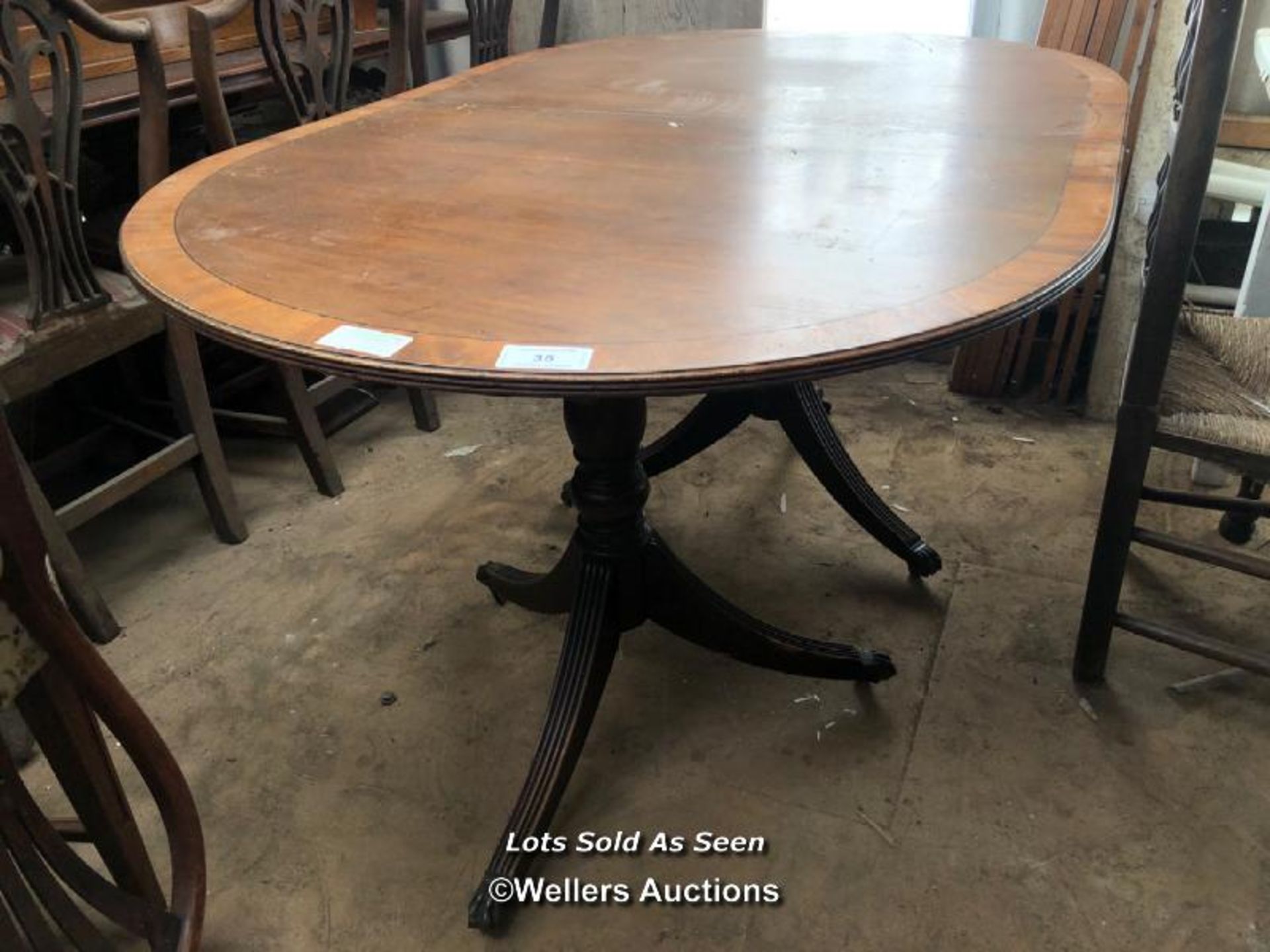 OAK OVAL EXTENDING DINING TABLE ON TWO TRIPOD BASES WITH CLAW FEET, 59.5 X 38.5 X 29.5 INCHES /