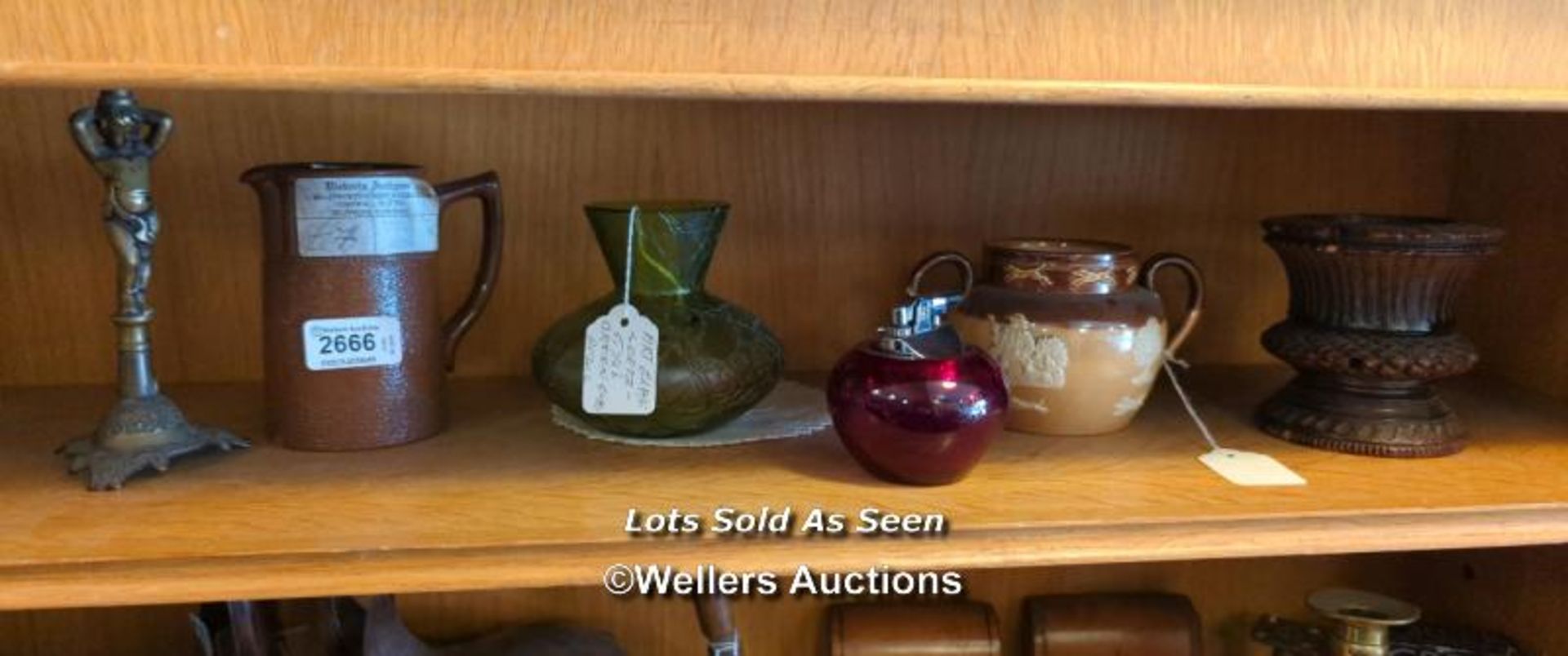 *SHELF OF ASSORTED ITEMS INCL. TABLE LIGHTER AND ROYAL DOULTON TWIN HANDLED POT / LOCATED AT