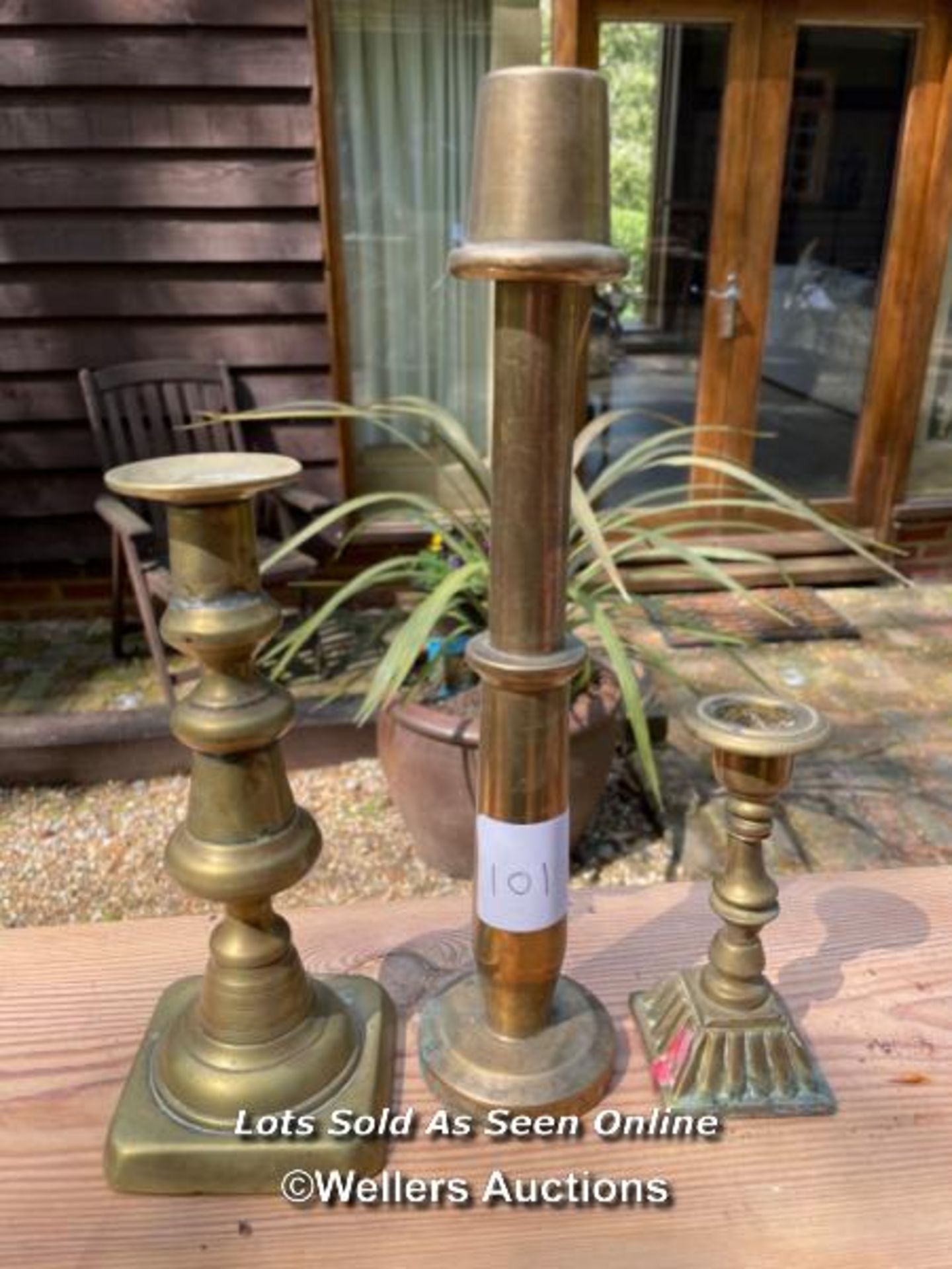 THREE VARIOUS BRASS CANDLE STICKS, TALLEST 28.5CM / COLLECTION LOCATION: WOKING (GU24), FULL ADDRESS