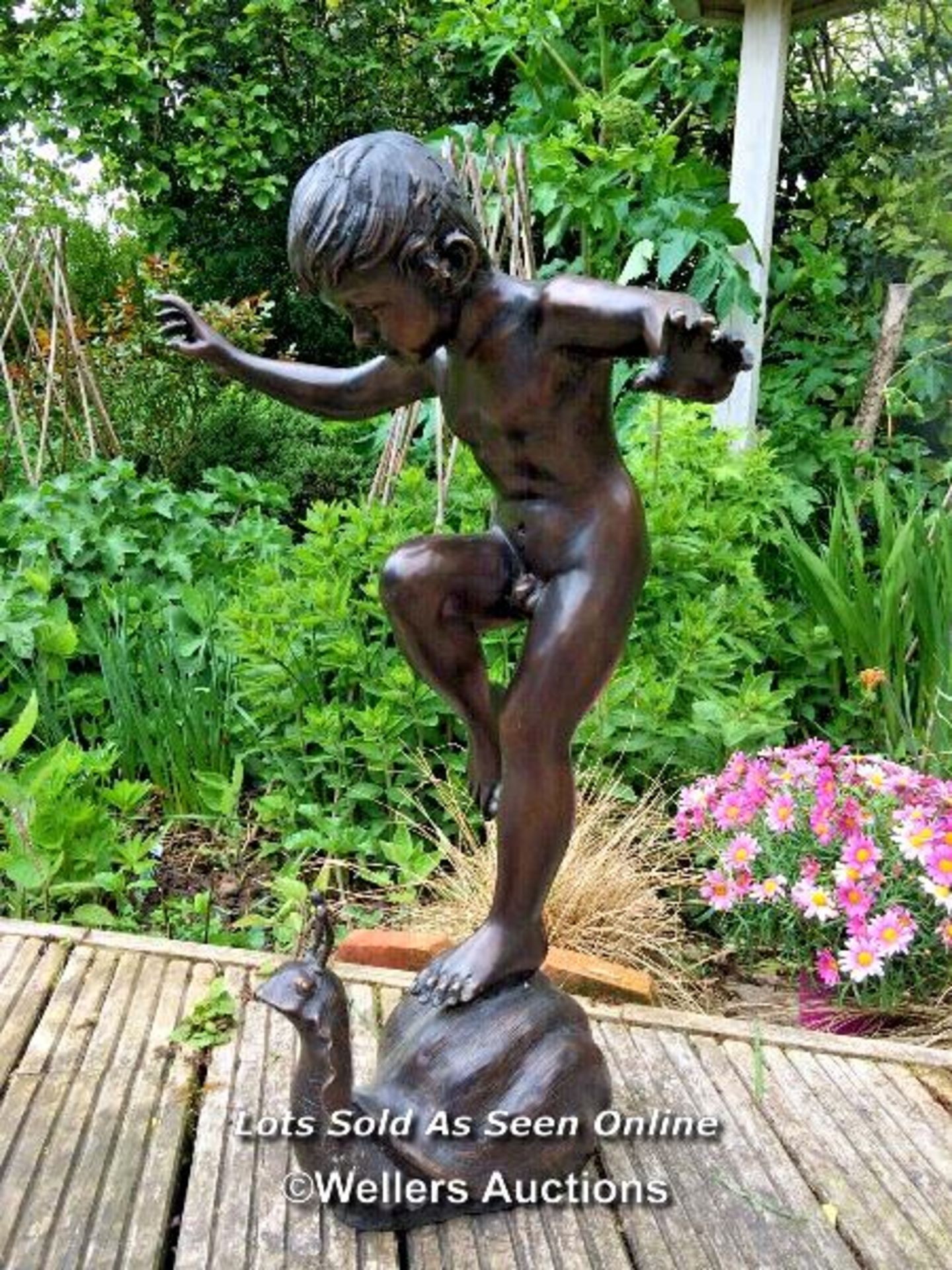 *GARDEN WATER FEATURE OF A BRONZE BOY ON SNAIL, SNAIL IS PIPED FOR WATER SO CAN BE USED AS A WATER