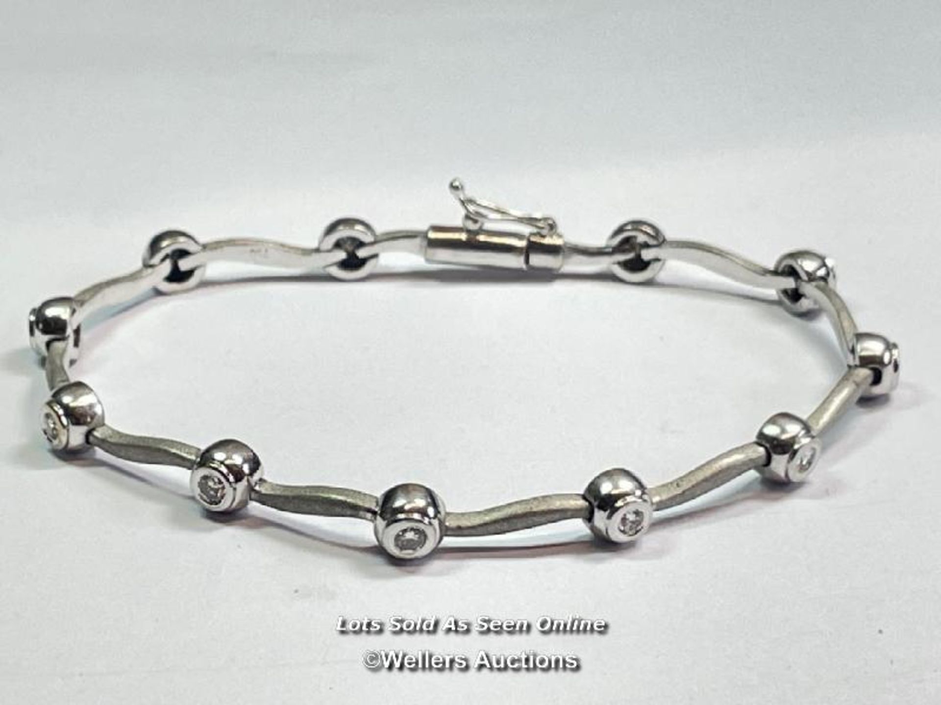 DIAMOND LINK BRACELET, ELEVEN ROUND DIAMONDS IN RUBOVER SETTINGS, PART POLISHED PART SATIN FINISHED.