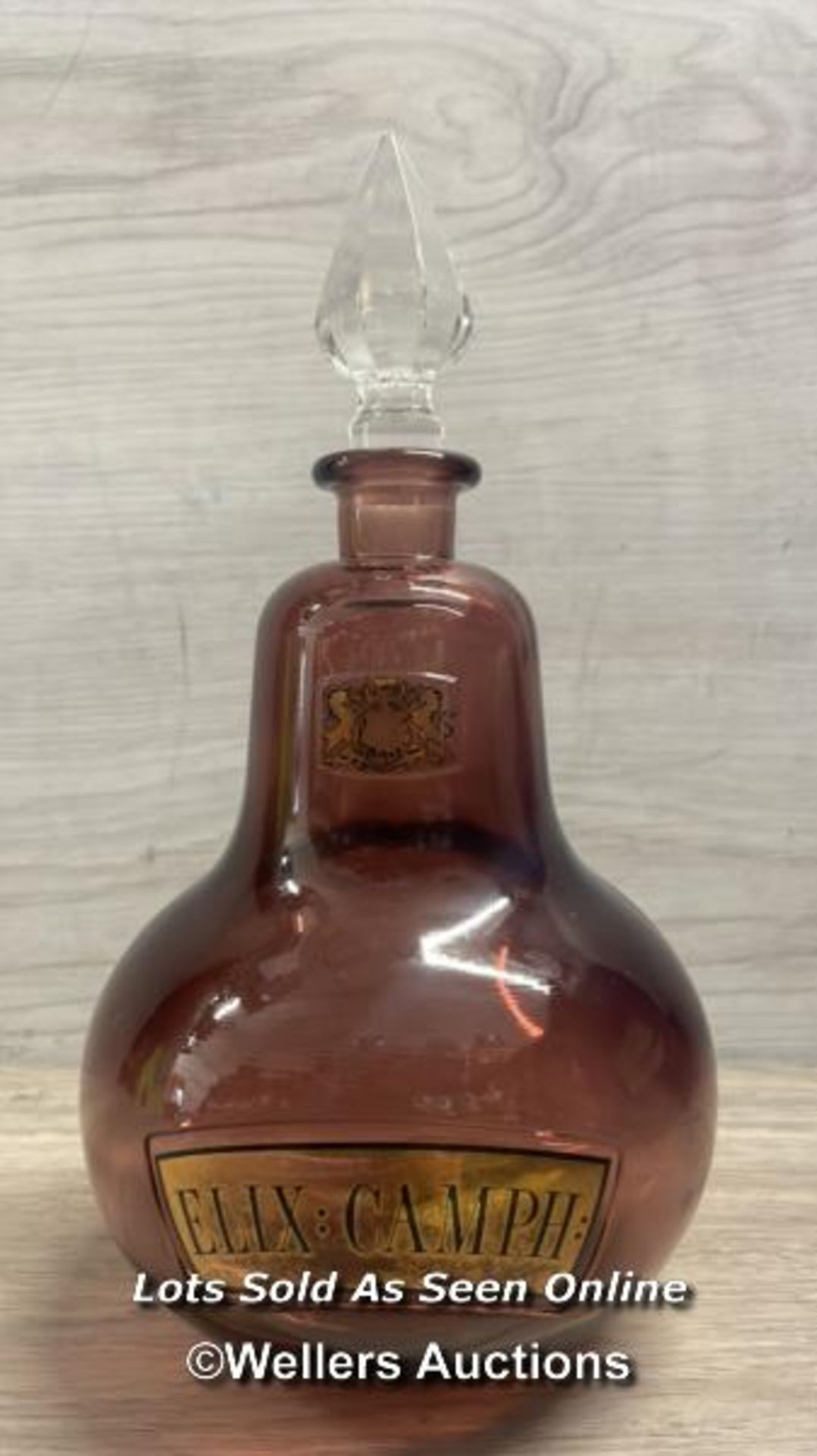 A RARE ROYAL PHARMACEUTICAL SOCIETY APOTHECARY BOTTLE, C1960'S, IN DARK MAUVE GLASS WITH GOLD LEAF