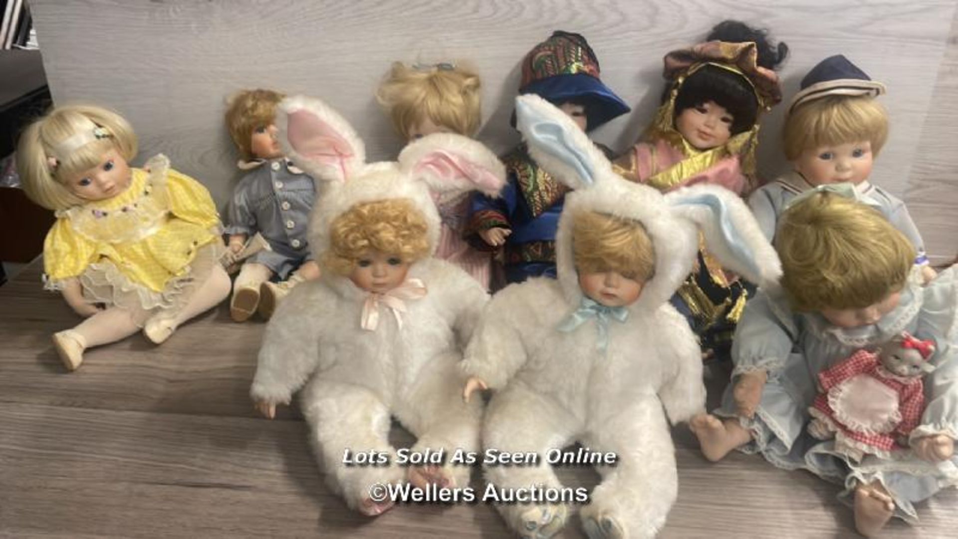 NINE COLLECTABLE PORCALAIN DOLLS