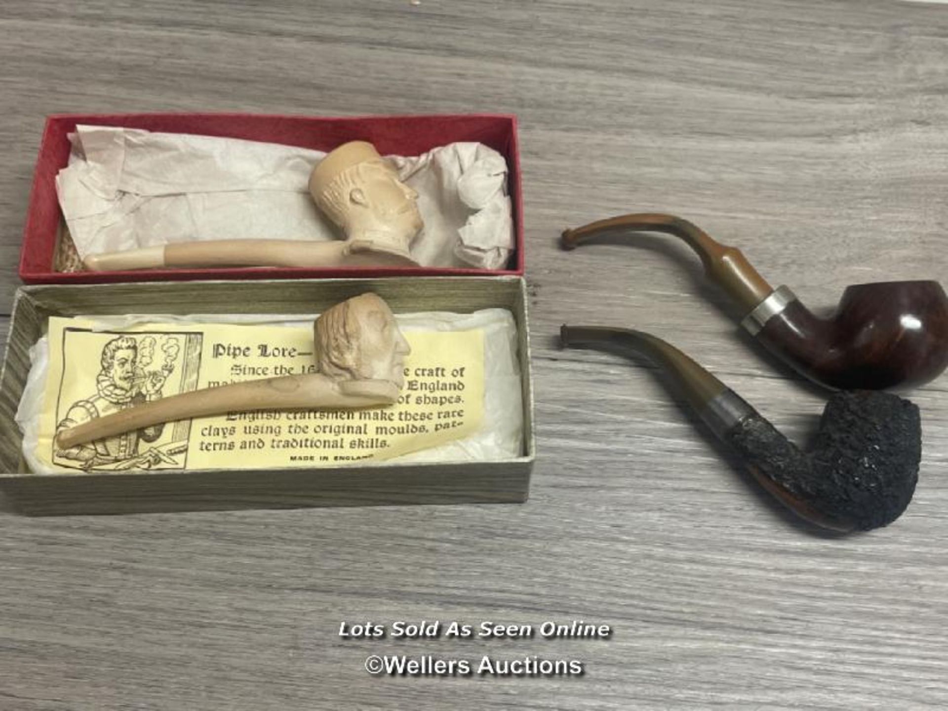 *TWO CLAY SMOKING PIPES BY JOHN POLLOCK & CO WITH TWO MORE PIPES, ONE WITH A HALMARKED SILVER NECK